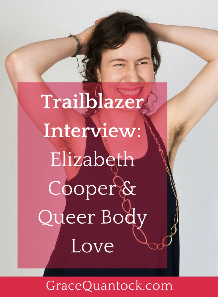 Image of Elizabeth Cooper with arms above her head showing underarm hair. Wearing a navy tunic and silver link necklace. Text: Trailblazer Interview: Elizabeth Cooper & Queer Body Love 