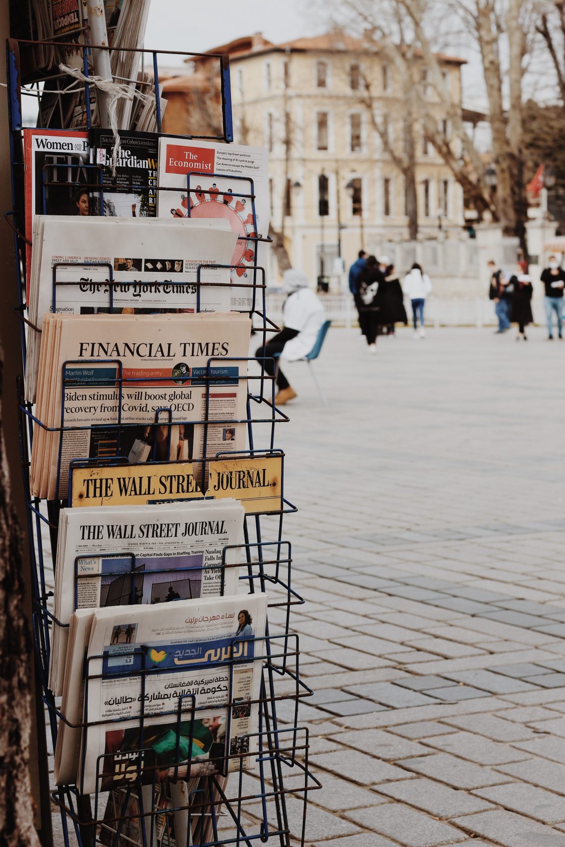 Newsstand of papers in a city.