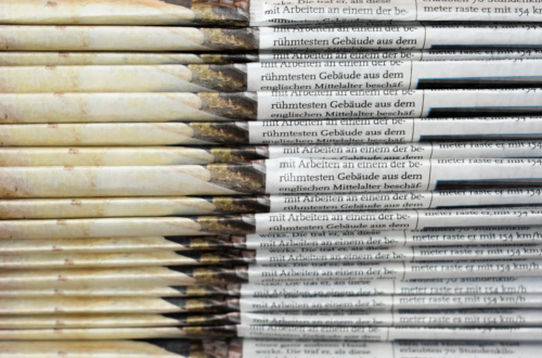 Pile of printed newspapers.